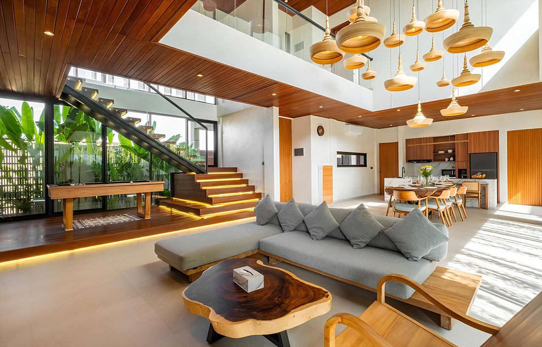 Sunlit open-plan living area of a modern luxury villa in Bali