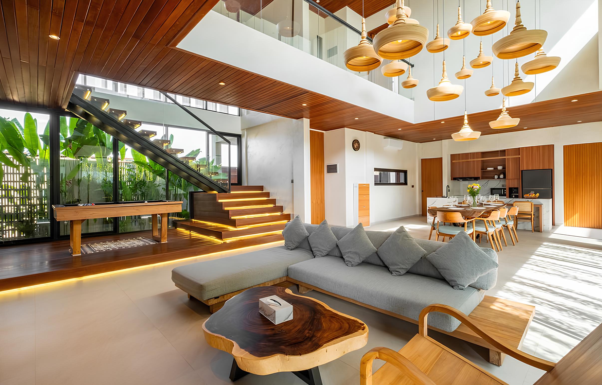 Sunlit open-plan living area of a modern luxury villa in Bali